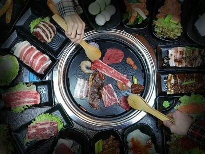 Mesa de restaurante coreano. Além de toda a carne, os acompanhamentos são um show à parte. Banchan é o nome dos famosos acompanhamentos que vem em grande variedade e pequenas quantidades, para que você coma junto com arroz e o prato principal