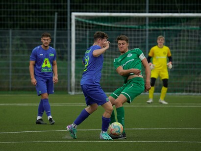 Two players battle for control of the ball, reflecting the fierce competition that energizes fans