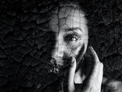 A woman looks at her cracked appearance