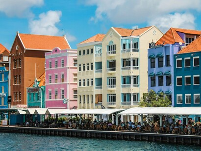 The distinctive gables and colorful facades seen in the photo are hallmarks of Willemstad's prosperity, stemming from its history as a major Dutch West India Company port