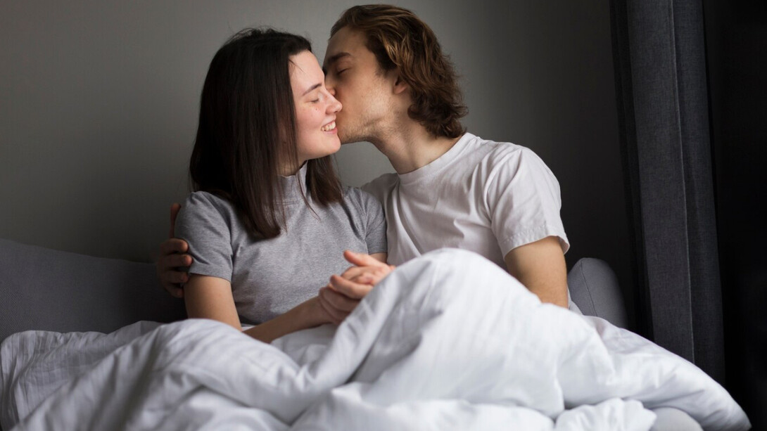 A couple in their bedroom sharing a moment of intimacy, a reminder that affection, legality and consent must go hand in hand 