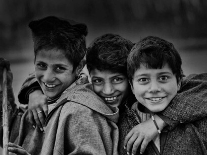 A group of pre-teen boys offering a wide variety of smiles ranging from the nervous to the joyous