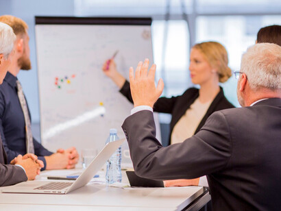 Executive inquiring during a business presentation