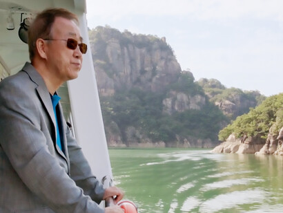 Ban Ki-moon looks forward on the boat