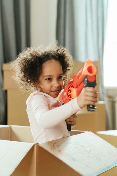 Young girl takes aim with her water gun