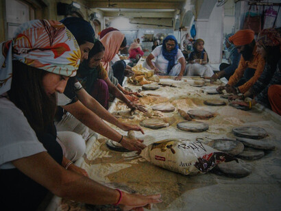 Sevaks (volunteers) rolling rotis for Langar