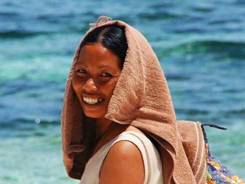 In the serene beauty of Mindanao’s coastline, this woman's natural smile embodies the joy and optimism that have emerged as the region blossoms into a land of opportunity