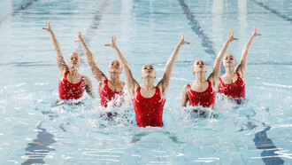 Experience the mesmerizing spectacle of synchronized dancing by women in a pool, blending grace and harmony in captivating movements