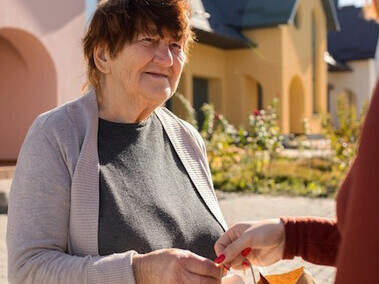 People bringing supplies to elderly neighbors, demonstrating generosity, reciprocity, and acts of kindness through giving and receiving
