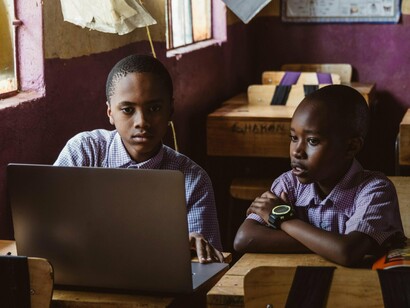 Young students learning through technology in a rural classroom, symbolising the promise of connectivity for a new generation