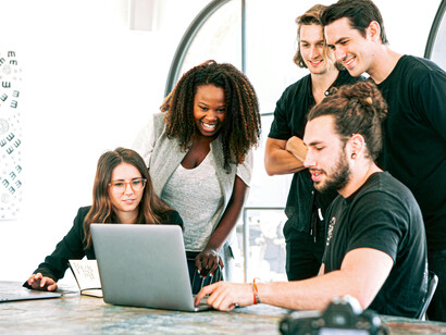 A small team of startup founders sharing ideas during a discussion in their office