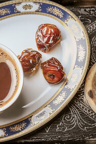 Experience the rich flavor of Turkish coffee with dates served on a tray, perfect for indulgence
