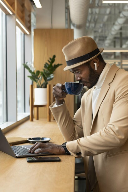 A professional balancing work and a coffee break, symbolising how self-presentation and ability work together to shape success