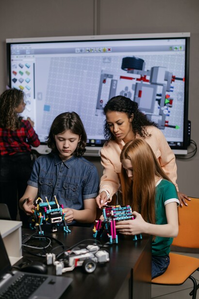 Two children being taught about robotics in a classroom 