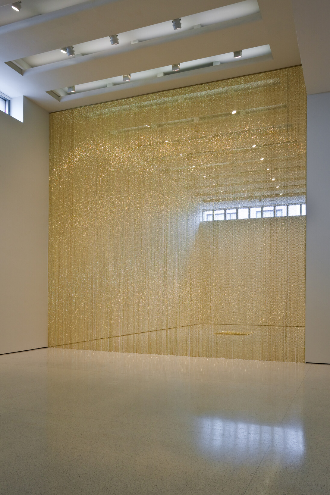 Felix Gonzalez Torres “Untitled” (Golden), 1995, Strands of beads and plastic track, dimensions vary with installation, Solomon R. Guggenheim Museum, New York, through prior gift of Solomon R. Guggenheim; The Art Institute of Chicago, through prior gift of Adeline Yates; San Francisco Museum of Modern Art, through prior gifts of J. D. Zellerbach, Gardner Dailey, and an anonymous donor; partial gift of Andrea Rosen in honor of Felix Gonzalez Torres 2008.22 © Estate of Felix Gonzales-Torres, Photo: David Heald, Solomon R. Guggenheim Foundation, New York

