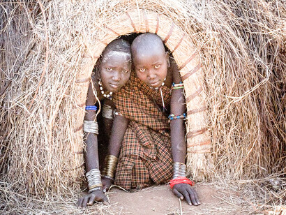 Mursi children in a hut. Mursi have a strong oral tradition that they use to communicate and preserve their history, intellectual understanding, and moral tales