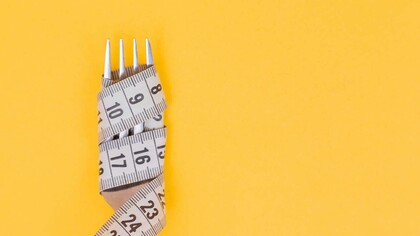 Measuring tape wrapped around a fork, showing the importance of addressing the causes of obesity