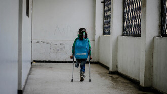 A young girl, who lost her leg in the war, walking to school in Idlib, Syria, highlighting the resilience of children in conflict zones