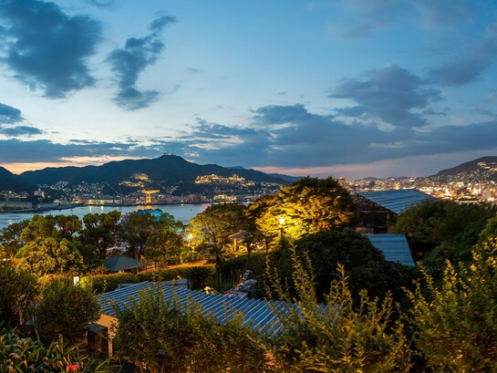 The evening lights of Nagasaki seen from Glover Garden cascading across the hillsides, reflecting the city's warm and enduring spirit 