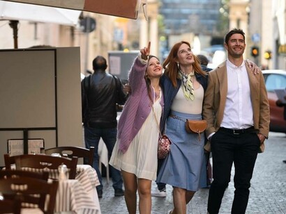 Photojournalist and Licensed Tour Guide Eva Soproni pointing out the monuments of Rome to her clients on a Vespa