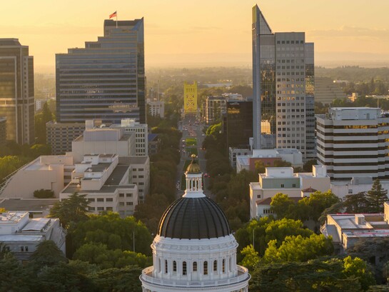 The California State Capitol rising above the city skyline in Sacramento, U.S., representing the relationship between government institutions and the forces reshaping contemporary politics