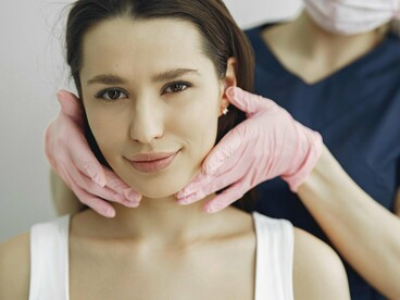 A woman undergoing aesthetic treatment, symbolising the subtle pressure to reshape identity into something more acceptable