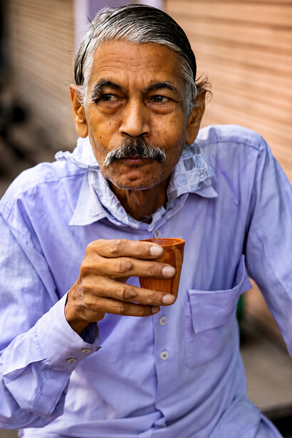 Local resident sipping chai on a quiet street in Jaipur, India