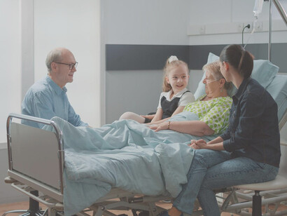 A niece lovingly hugs her sick aunt during a family visit in the hospital ward, sharing a poignant moment before euthanasia
