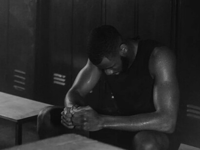 A solitary male athlete in the locker room, battling stress and anxiety