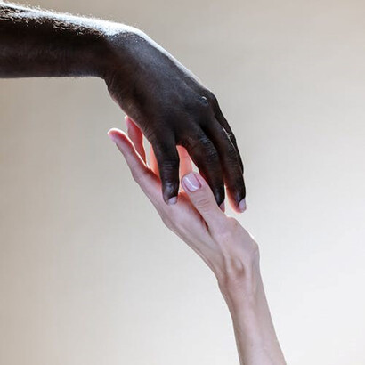 The couple shares a tender moment as they hold hands, their fingers entwined in a gesture of affection and unity