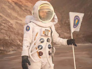 A male astronaut signaling his location during a space mission on an unknown planet