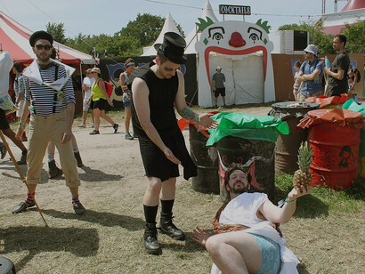 Street performers bringing color and energy to the crowds at Glastonbury Festival, England