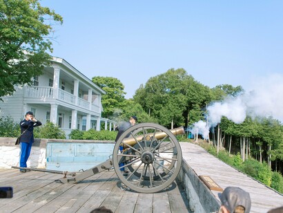 A live artillery demonstration overlooking the island landscape, representing Mackinac Island’s rich military heritage