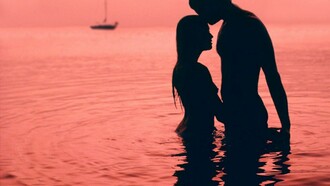 Pareja de enamorados bañándose en el mar