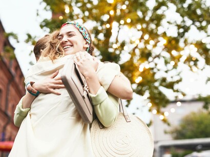 A hug between friends signifies their care for one another