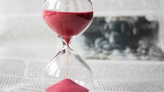 The hour glass symbolizing that our time is slipping away
