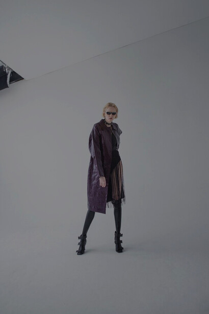 A model flaunts sunglasses in a high-fashion shoot, highlighting luxury brands and contemporary design