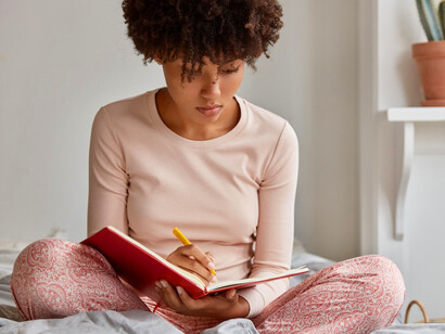 By outlining achievable goals in her journal, she transforms big ambitions into manageable steps she can tackle with confidence