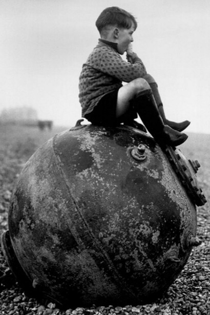 A child, sitting in a huge bomb