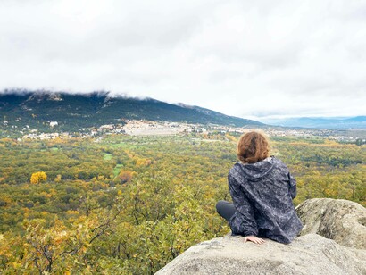 Traveling solo to familiar destinations in nature can offer a degree of comfort while sitting on a rock and admiring the breathtaking view