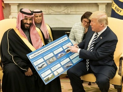 President Donald J. Trump, joined by Crown Prince of Saudi Arabia Mohammed bin Salman, shows informational boards showing how much business the Kingdom of Saudi Arabia generates in the United States economy, at their meeting in the Oval Office at the White House, Tuesday, March 20, 2018, in Washington, D.C