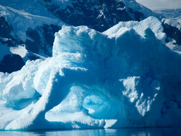 Sculpted Antarctic ice extending into the sea, symbolizing the environmental and strategic importance of the polar region