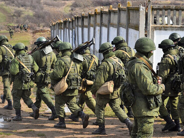 Unmarked armed personnel at Simferopol Airport on 28 February 2014, illustrating the use of ambiguity and deniability during the annexation of Crimea