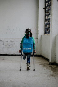 A young girl, who lost her leg in the war, walking to school in Idlib, Syria, highlighting the resilience of children in conflict zones