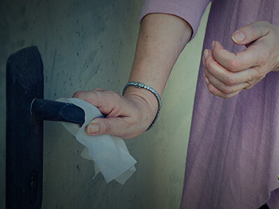 A woman scared by germs. OCD; creates the worry about contaminating the world with Armageddon-causing germs