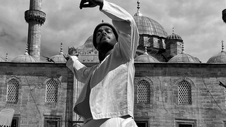 A dervish by a mosque 