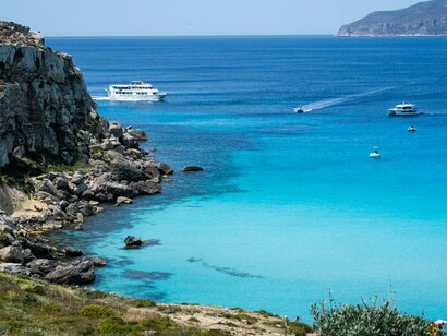 A picturesque scene of Sicily's coastline, with its sparkling blue waters and serene seaside landscape