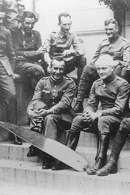 The Red Baron with his bandage seating with his flying circus in the summer of 1917, Carlos in the back row lighting a cigar