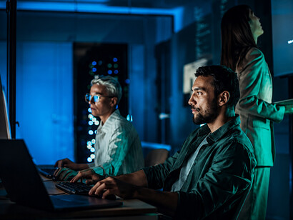 Cybersecurity operations center with military and civilian experts monitoring digital threats and network security