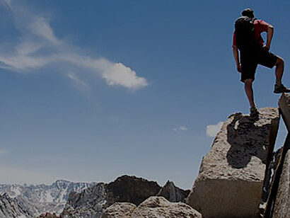 A man skillfully climbed the rocks on the mountain